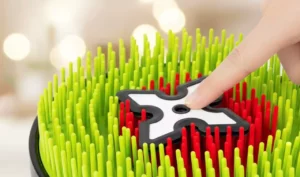 Main d'enfant enfonçant les picots souples de la cible de lancer interactive
